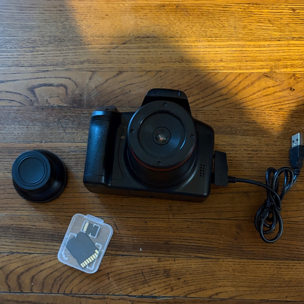 Black Compact Digital Camera with Lens Cap and SD Card